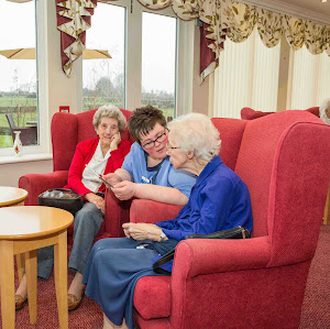 a carer advising two elderly ladies